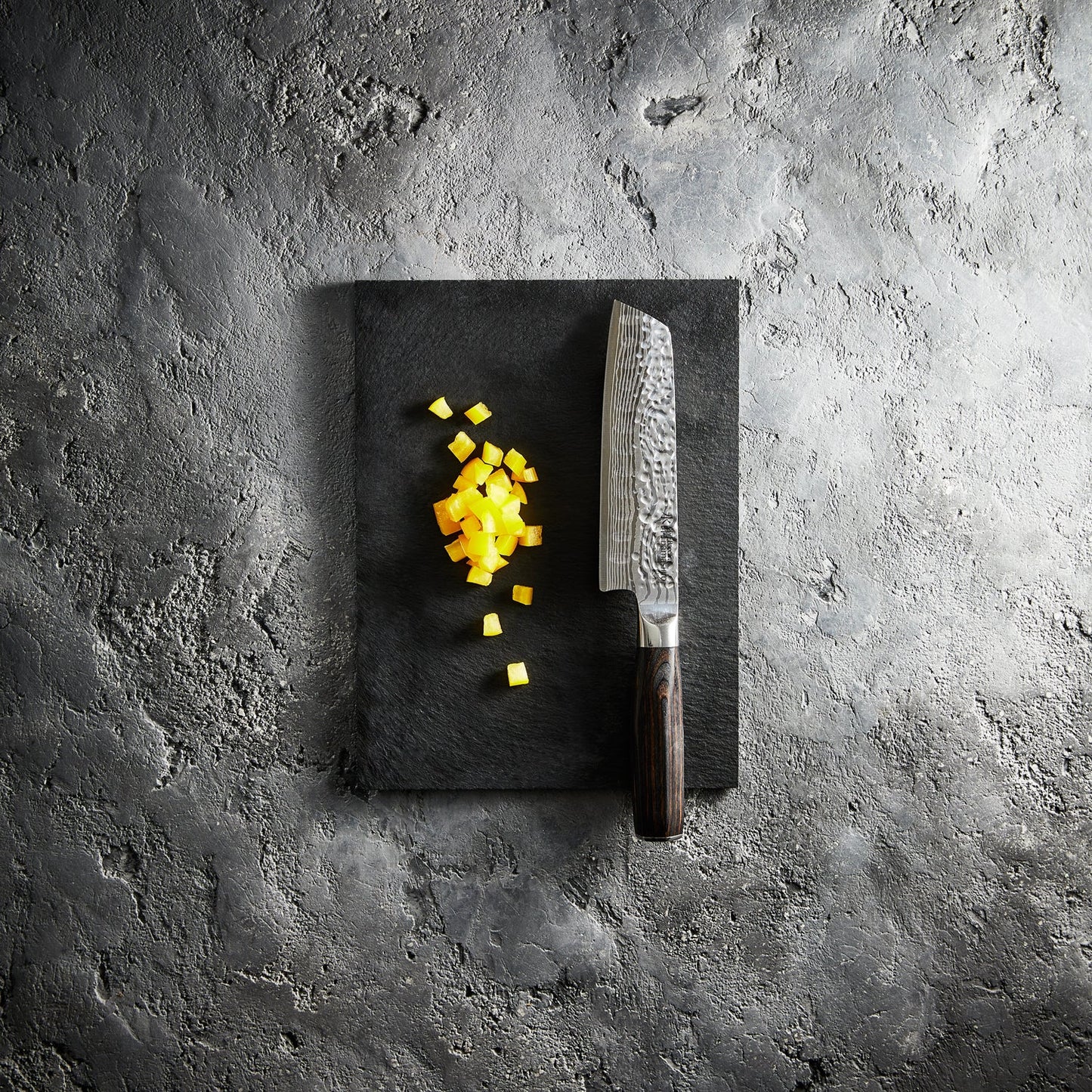 Diced mango on a dark cutting board with a sharp santoku knife - Baccarat damashiro emperor try me
