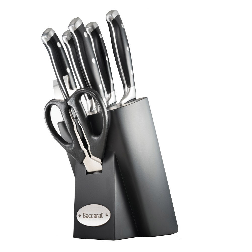 Top view of Baccarat Artisan Finster kitchen knives featuring sleek black handles on a wooden board