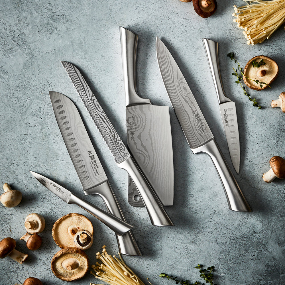 Golden brown bread slices beside a Baccarat Damashiro Bread Knife 20cm on a textured surface 