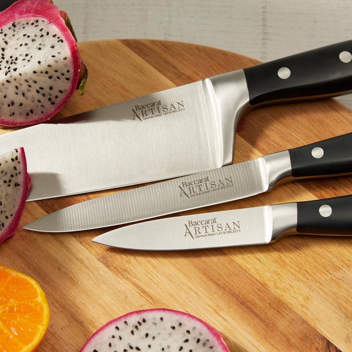 Wooden cutting board with fresh veggies and fruits and sleek black knives - Baccarat Artisan Stahl