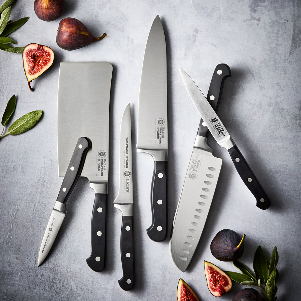 Wolfgang Starke stainless boning knife surrounded by figs and herbs on a grey surface - Baccarat 