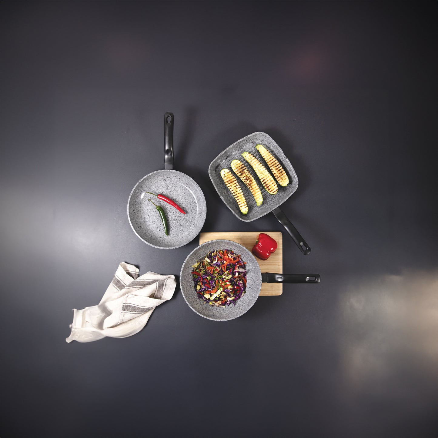 Set of cookware with food on a dark background
