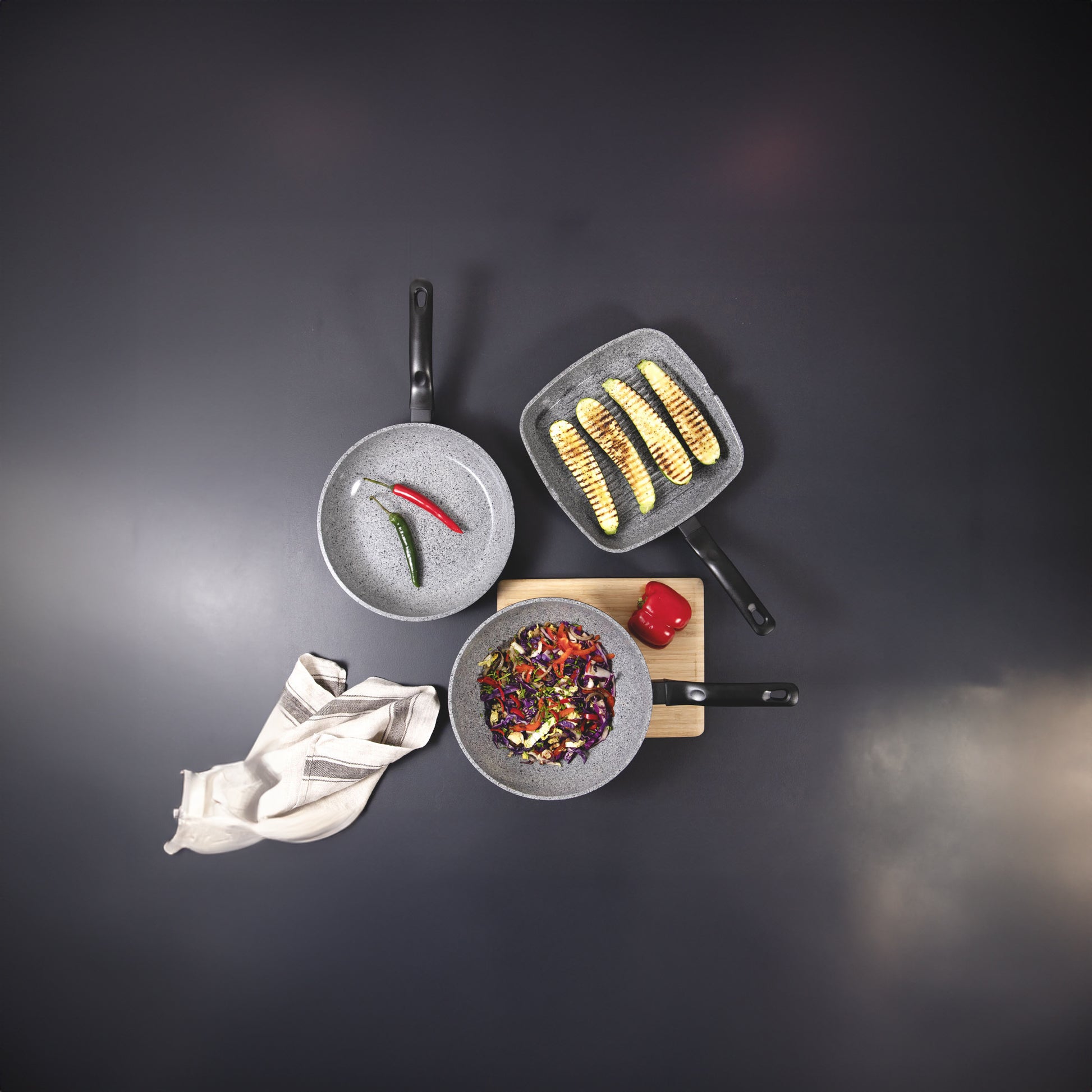 Set of cookware with food on a dark background