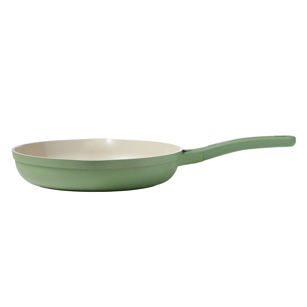 A side view of sage frying pan is on a white background.