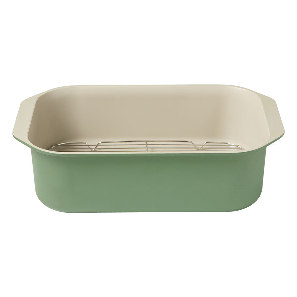 A rectangular sage green roasting pan with a wire rack inside is displayed against a plain white background.
