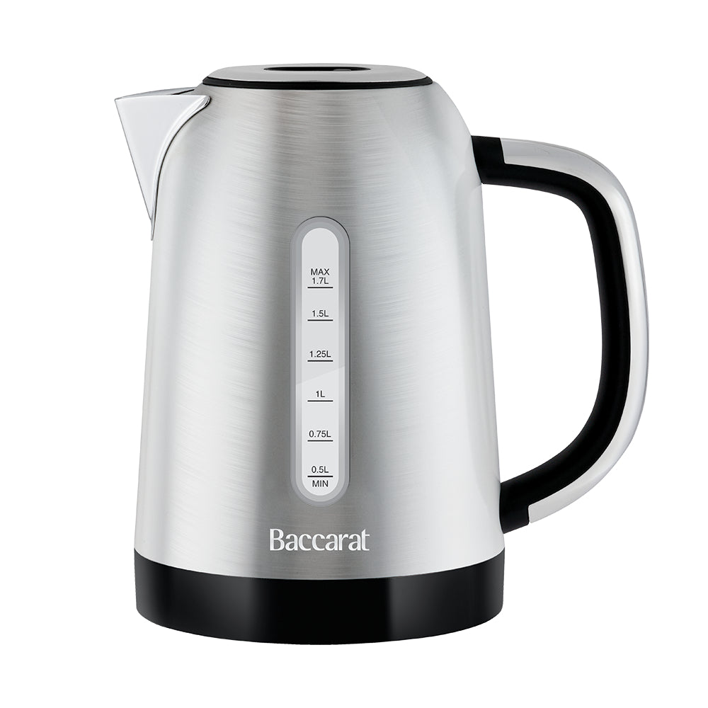 A Baccarat stainless steel electric kettle with a brushed silver finish, black handle and base, and white measurement markings on the front.