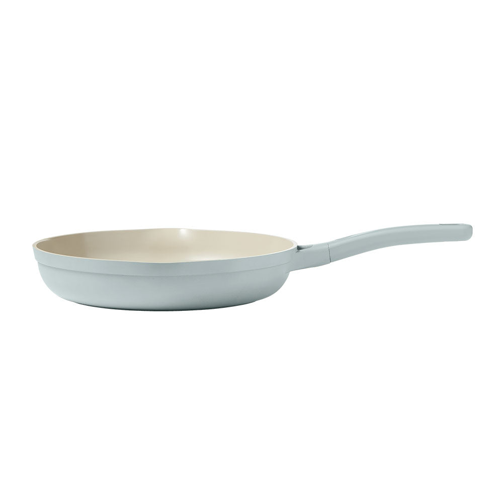 A side view of a light blue frying pan on a white background.