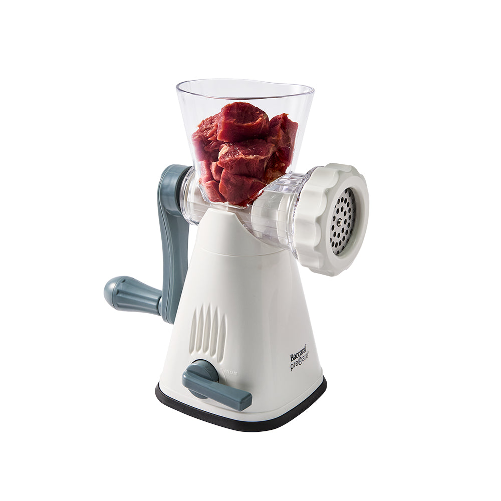 Manual meat grinder with ground beef in a clear container on a white background