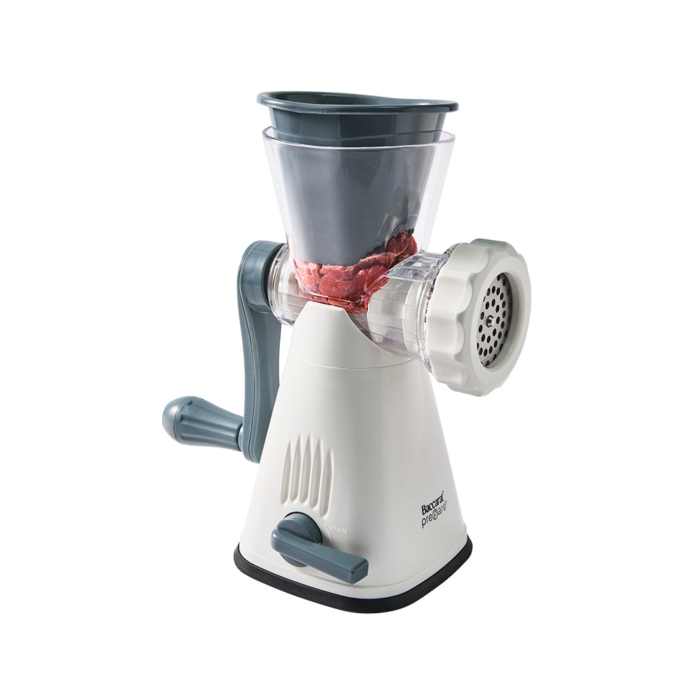 Manual meat grinder with a clear container on a white background