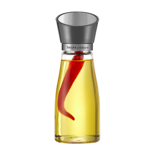 Baccarat Prepare Glass Oil Bottle with a red pepper inside on a white background