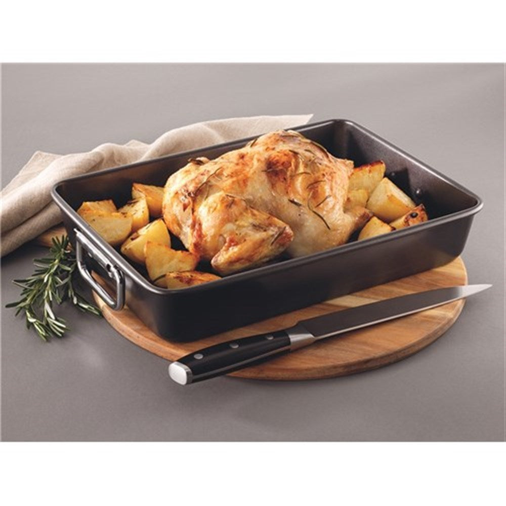 A roasting pan with vibrant vegetables and black finish - Baccarat gourmet roaster with rack 