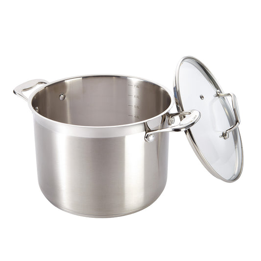 A silver stockpot with lid surrounded by kitchen utensils on a gray background - Baccarat