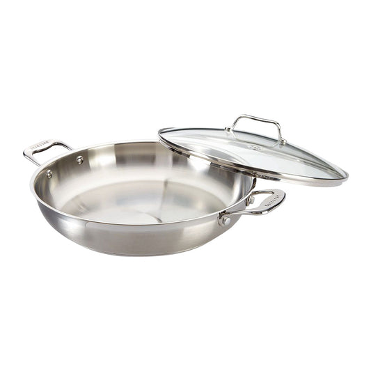 Overhead view of a stainless steel chef pan with lid and kitchen tools - Baccarat Iconix