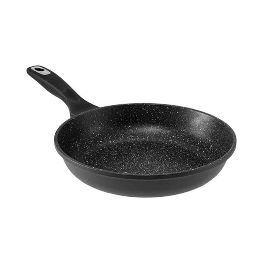 Person cooking vegetables in a granite frying pan 28cm with a pepper grinder nearby - Baccarat