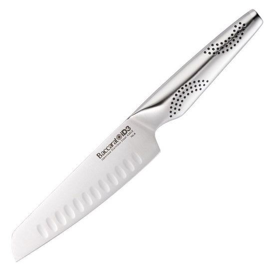 A knife on a wooden cutting board with chopped vibrant vegetables 20cm chefs knife - Baccarat