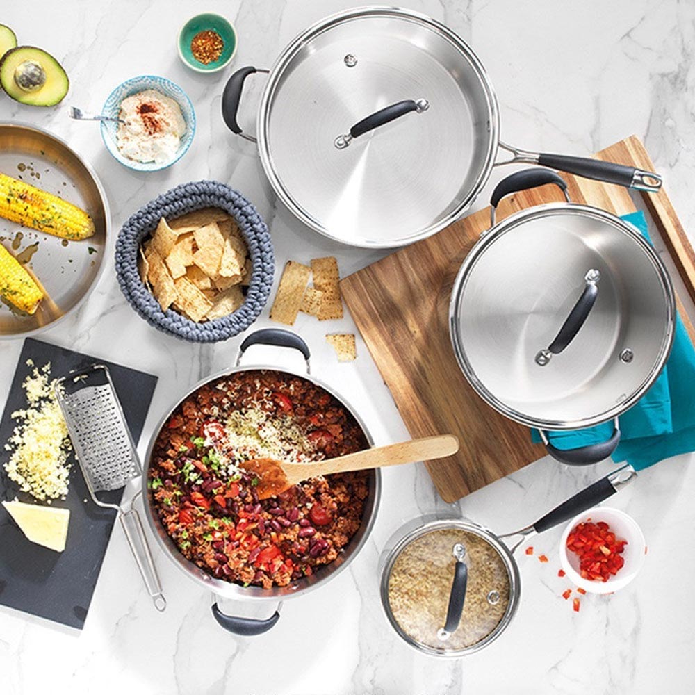 Shiny stainless steel pots, pans arranged on kitchen counter capri stockpot with lid 8 2l - Baccarat
