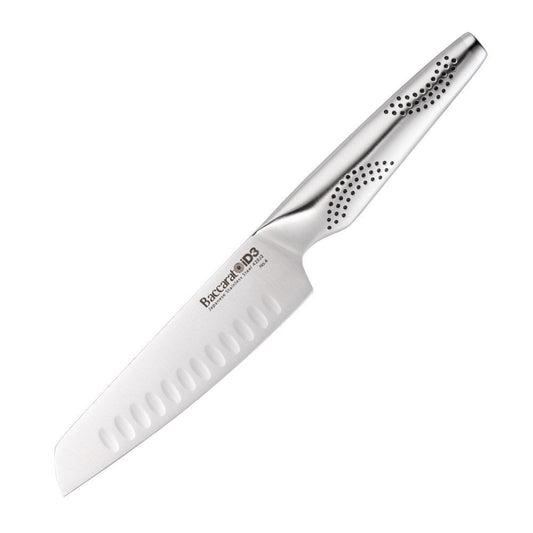 A sleek santoku knife rests on a wooden board surrounded by colourful sliced vegetables - Baccarat