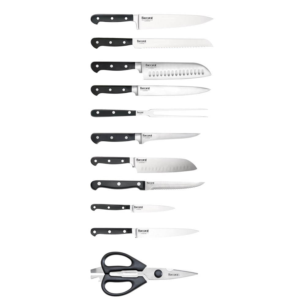 A selection of Sabre kitchen knives and scissors on cutting board with herbs and handles - Baccarat 