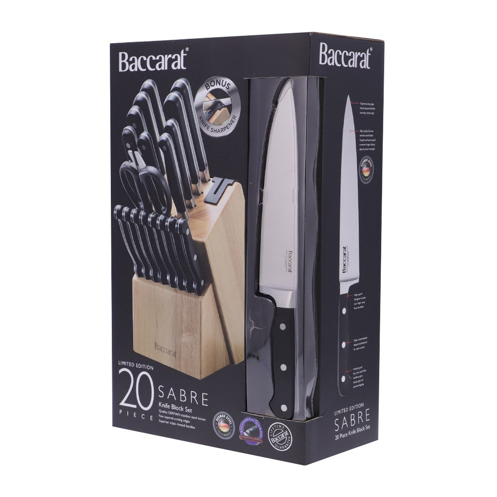 A selection of Sabre kitchen knives and scissors on cutting board with herbs and handles - Baccarat 