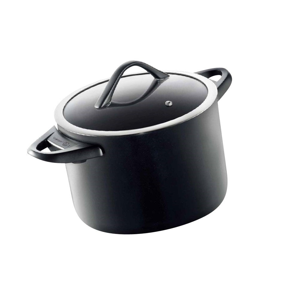 Round black stockpot with lid and bakelite handle filled with chopped carrots and greens - Baccarat