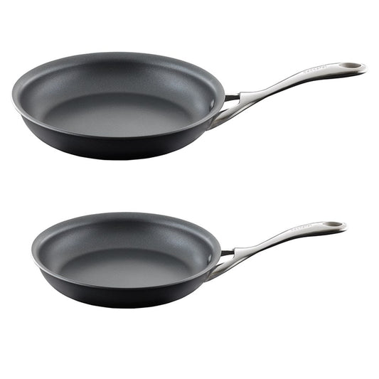 Two frying pans with bell pepper slices on a gray surface - Baccarat id3 hard anodised frypan