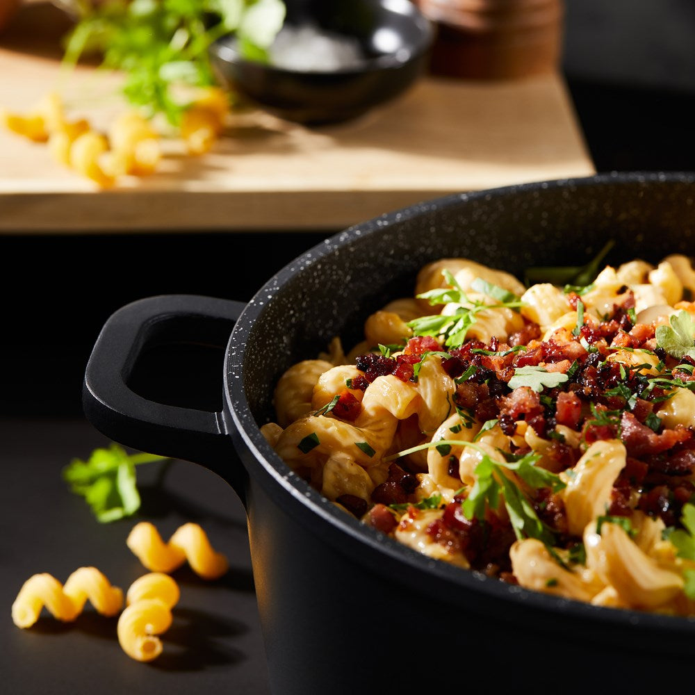 Baccarat Stone 4-piece Cookware Set features pots and pans with olive oil and pasta on a countertop 