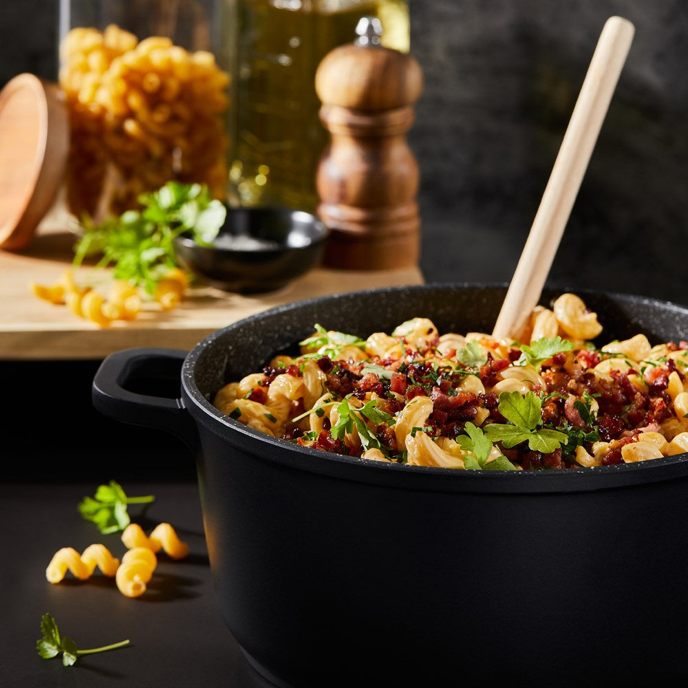 Baccarat Stone 4-piece Cookware Set features pots and pans with olive oil and pasta on a countertop 