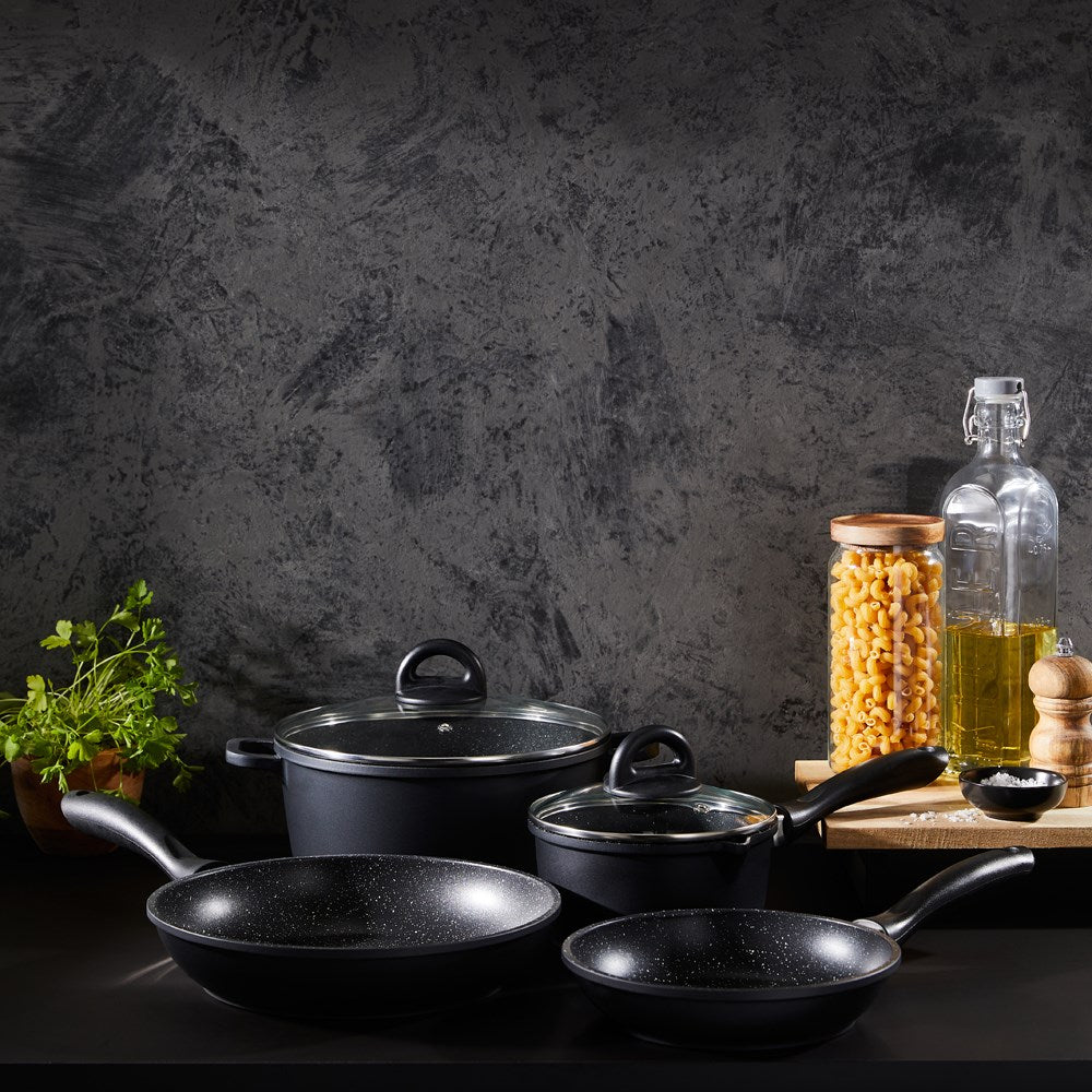 Baccarat Stone 4-piece Cookware Set features pots and pans with olive oil and pasta on a countertop 