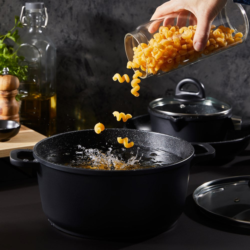 Baccarat Stone 4-piece Cookware Set features pots and pans with olive oil and pasta on a countertop 