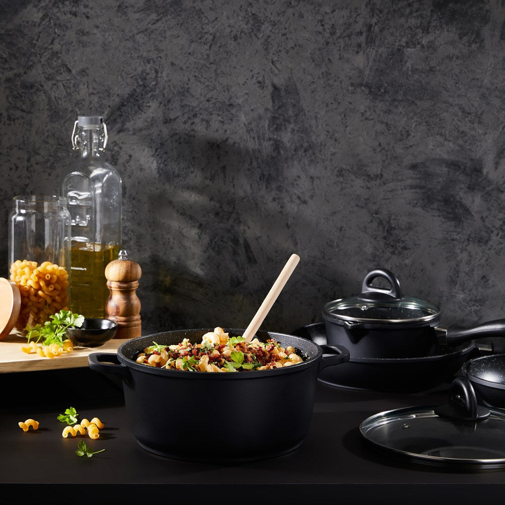 Baccarat Stone 4-piece Cookware Set features pots and pans with olive oil and pasta on a countertop 