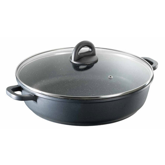 Overhead view of a frying pan filled with green beans and onions on a grey surface - Baccarat