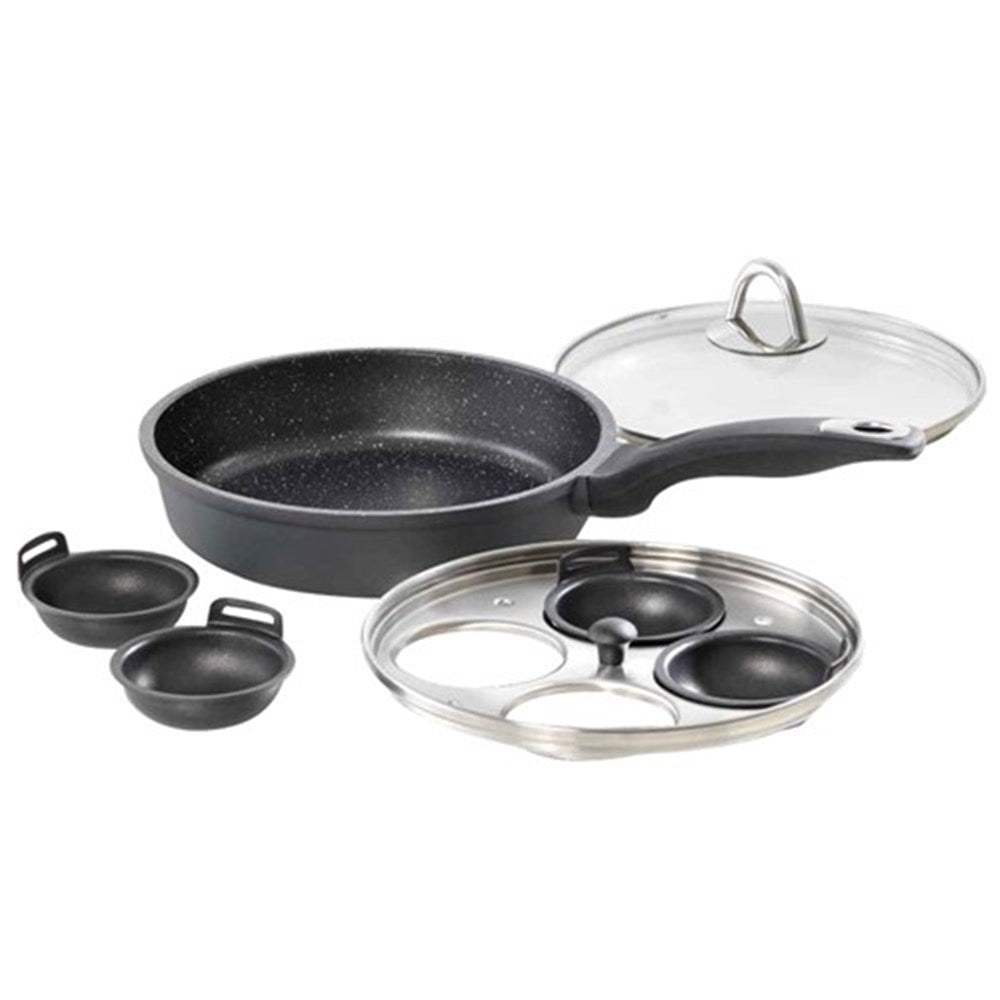 A sleek egg poacher with four sections surrounded by fresh eggs and greens - Baccarat granite