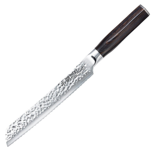 A Baccarat Emperor 20cm bread knife with a sharp edge on a wooden surface surrounded by other knives