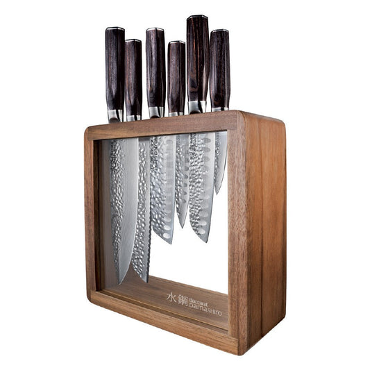 Seven sleek knives in a stylish wooden block on a countertop gleaming in light - Baccarat damashiro