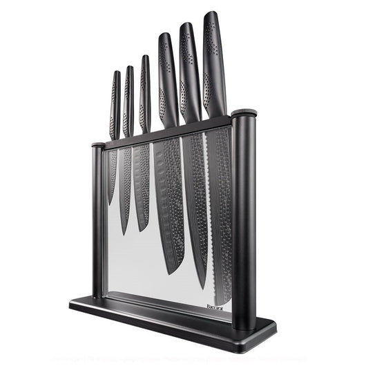 A person chops cabbage on a modern counter with a black knife block displaying knives - Baccarat