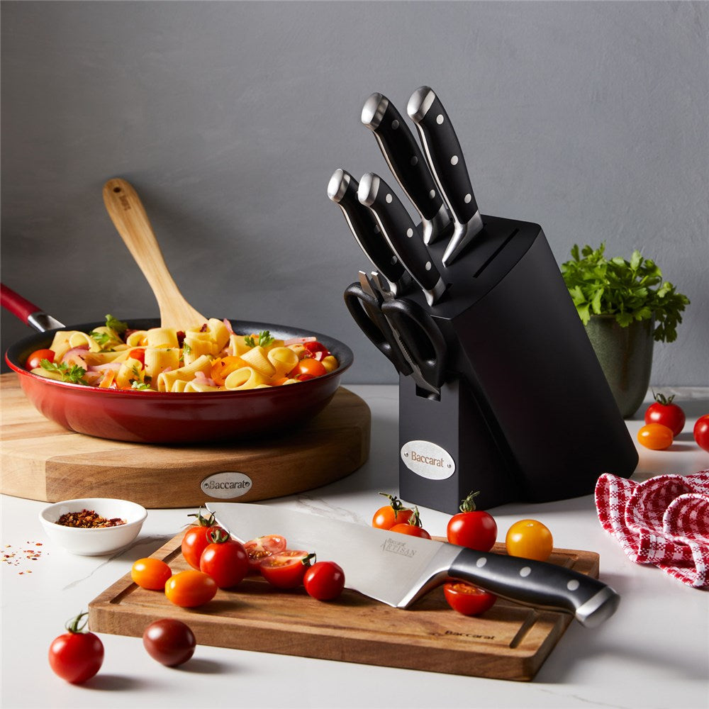 Top view of Baccarat Artisan Finster kitchen knives featuring sleek black handles on a wooden board
