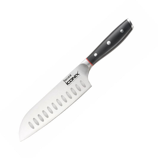 A sleek Baccarat Iconix Santoku Knife with a black handle and silver blade beside its packaging