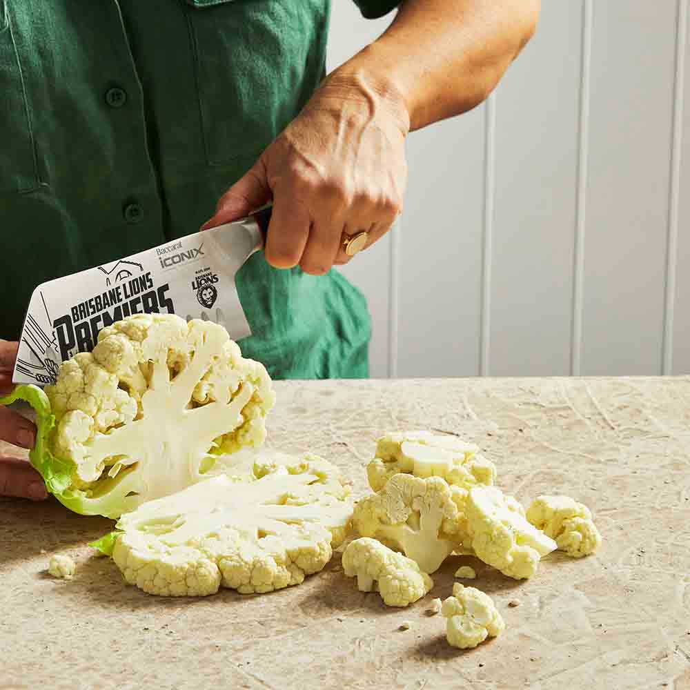 Sliced cauliflower next to a 17 5cm textured surface black handle cleaver knife - Brisbane Lions