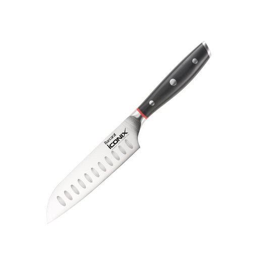 A sleek santoku knife with black handle on a wooden strip against a grey wall knife - Baccarat