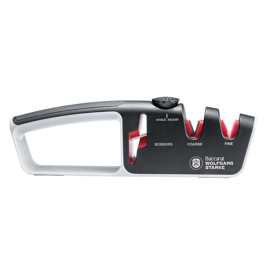 Person sharpening a knife with a black and red santoku knife 18cm - Baccarat wolfgang starke