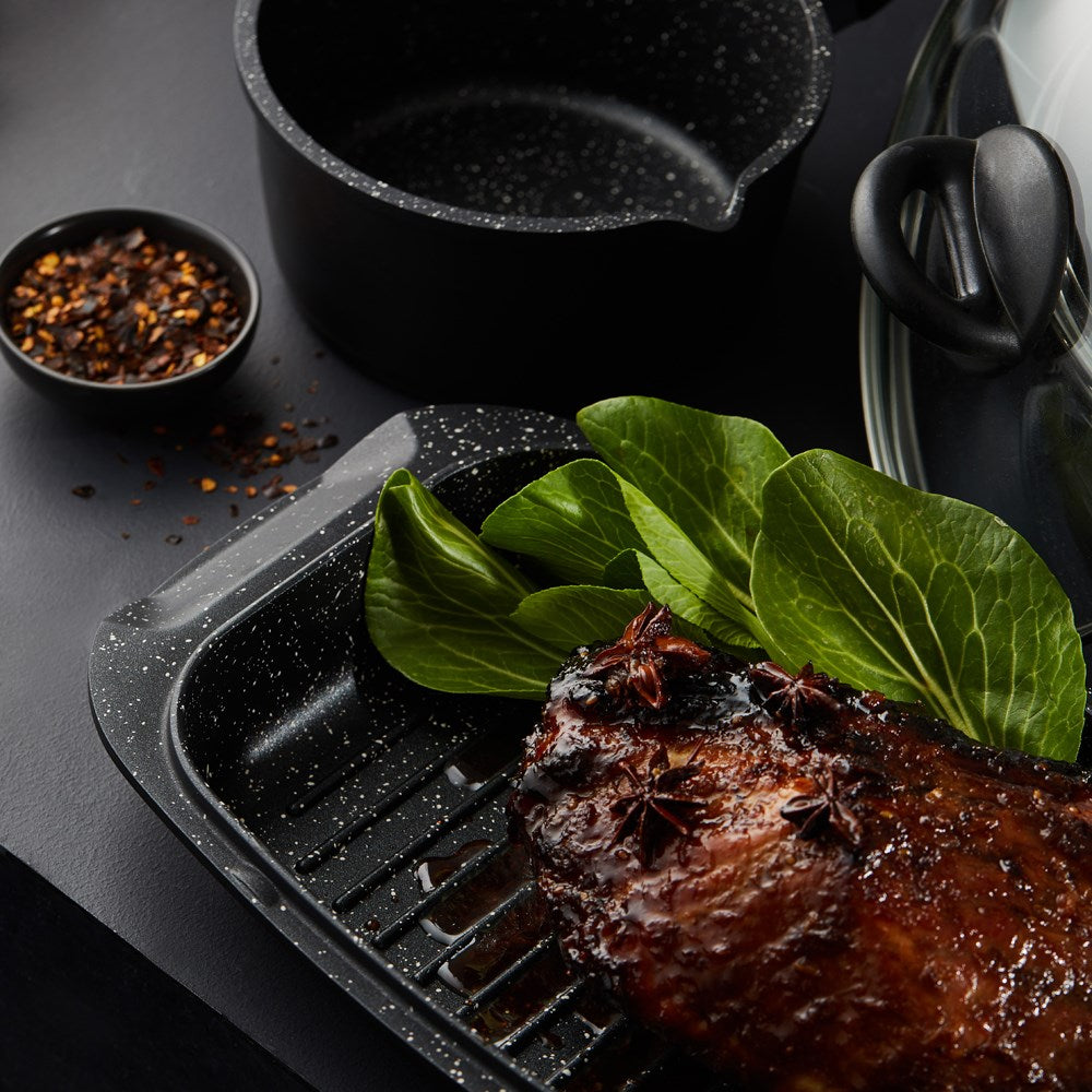 A complete cookware set with pots pans and a grill pan featuring black non-stick surfaces - Baccarat