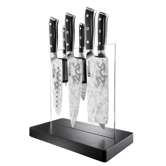 Sleek stainless steel knives next to sliced mushrooms and garlic premium black handles - Baccarat
