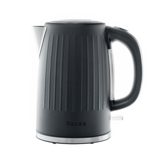 Black kettle pours hot water into a white cup beside a pastry plate - Baccarat  Boiling Point Kettle