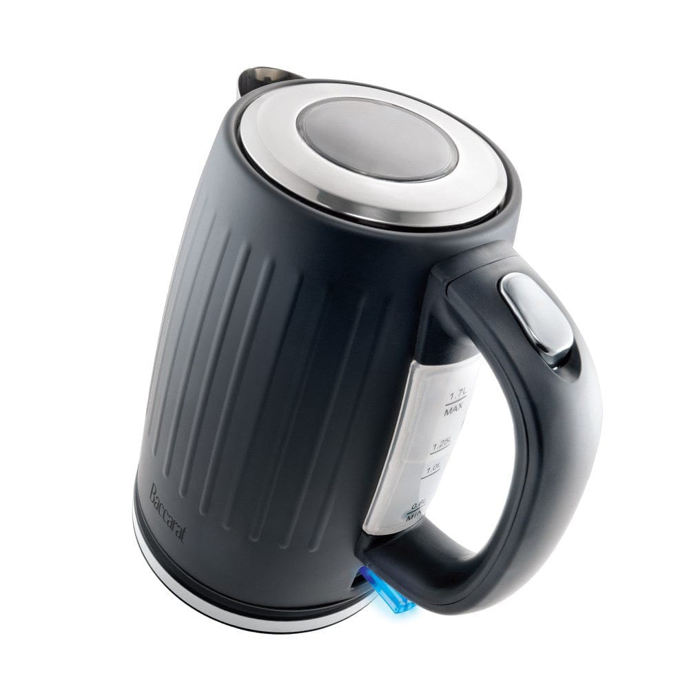 Black kettle pours hot water into a white cup beside a pastry plate - Baccarat  Boiling Point Kettle
