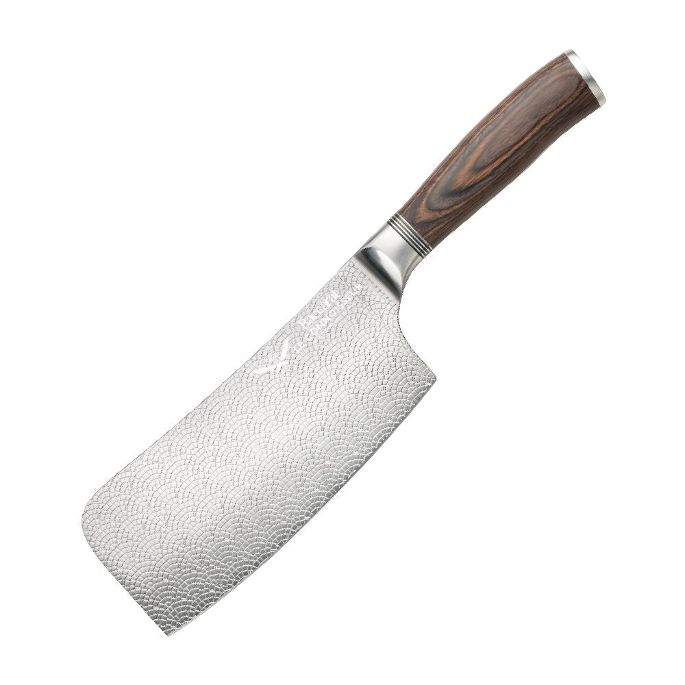 A hand slicing a red tomato with silver cleaver on a wooden cutting board  - Baccarat Le Connoisseur