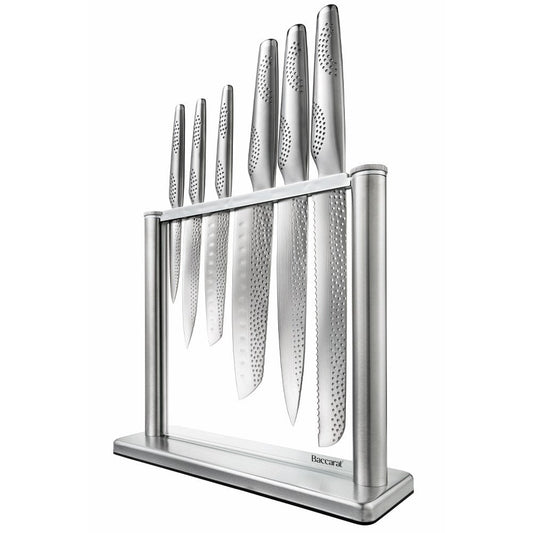 A polished knife block set with sharp blades and sleek design next to fresh vegetables - Baccarat