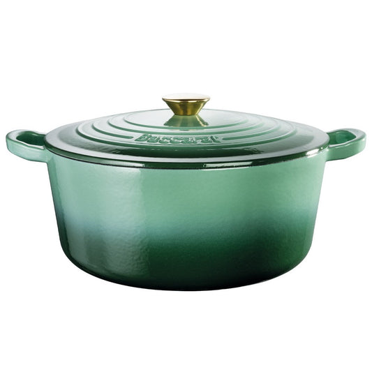 Green Baccarat Le Connoisseur French Oven with lid on countertop surrounded by herbs and a plant