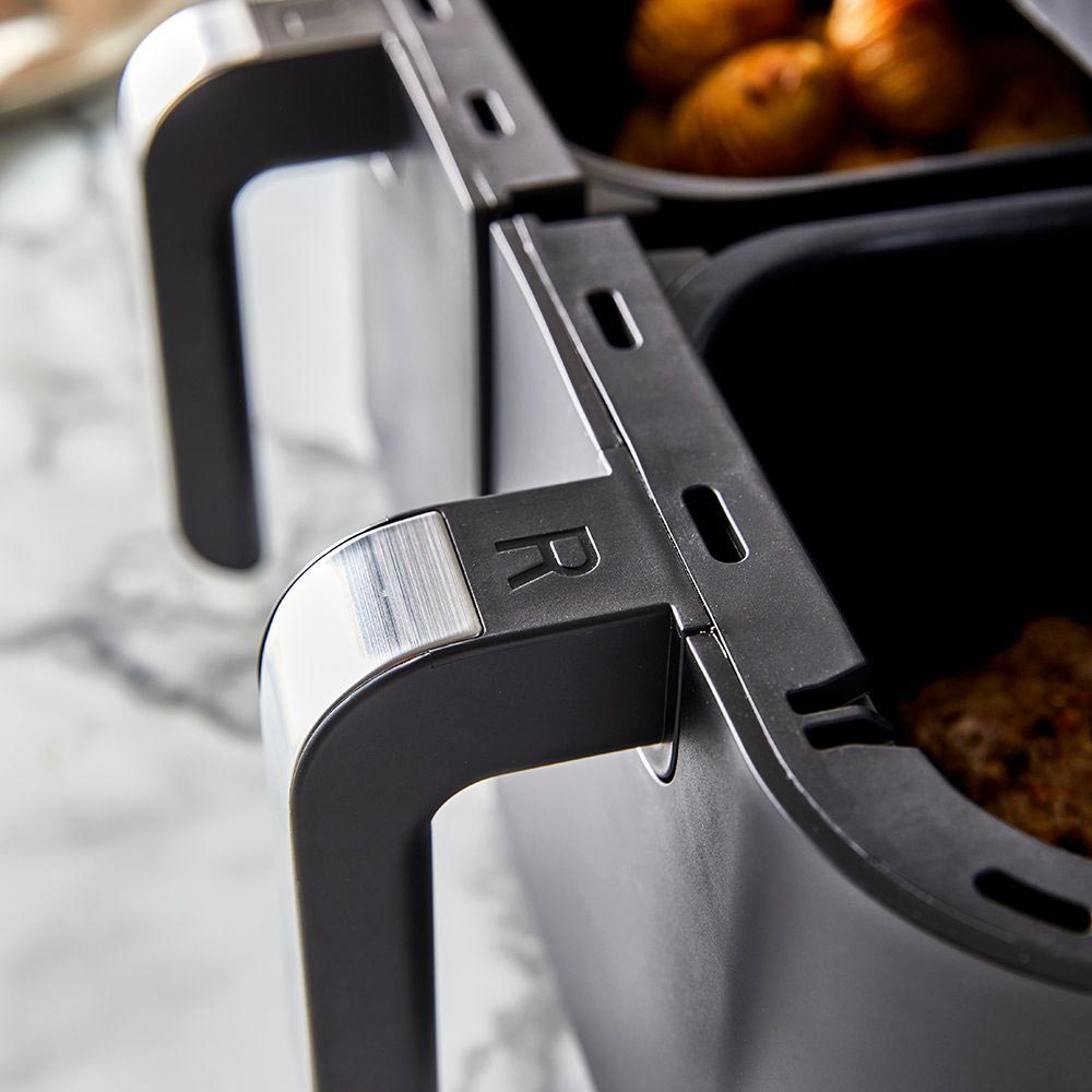 Close-up of a sleek black loaf bread maker with removable baskets and cooked potatoes - Baccarat