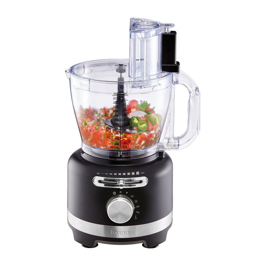 black air fryer with green ingredients on marble counter near dishes and a spice grinder - Baccarat