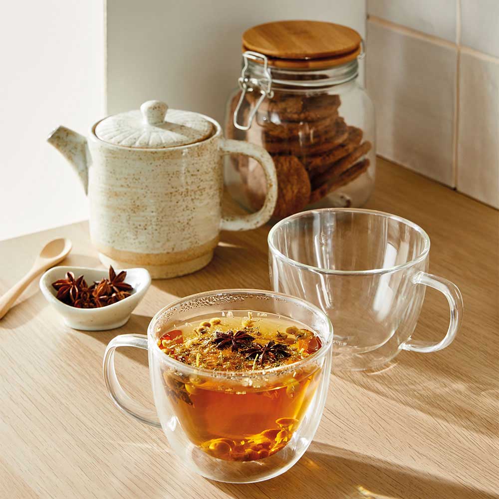 A glass cup filled with dark amber tea transparent beverage container - Baccarat barista brillante